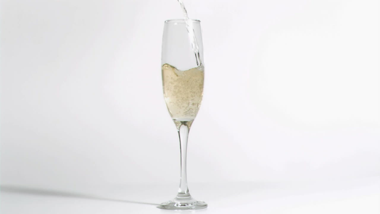 Animation of burning layer over glass of champagne on white background