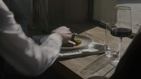 Waitress Brings Gourmet Dishes to Guests African American Man and Asian Woman Sitting at the Table Near Window Drinking Wine and Waiting Order Waitress Brings Gourmet Dishes to Guests Multi Ethnic People in Restaurant with Modern Design