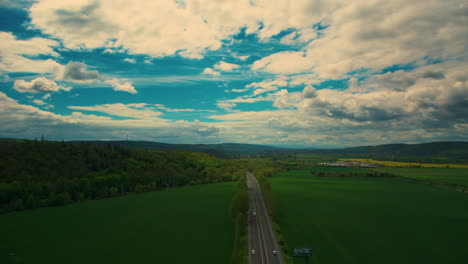 Aerial-top-down-view-on-multilevel-interchange-overpass-in-Zbraslav-showing-afternoon-traffic-under-sun-and-cloud