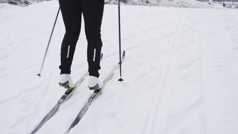 tracking medium shot of lower body of a cross country skiier