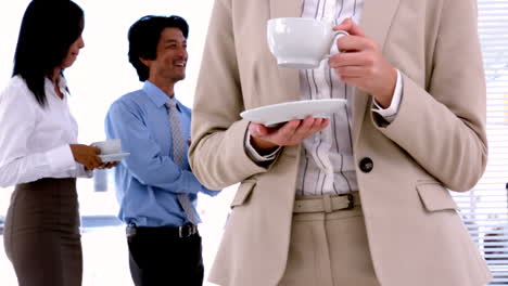 business people standing and having coffee