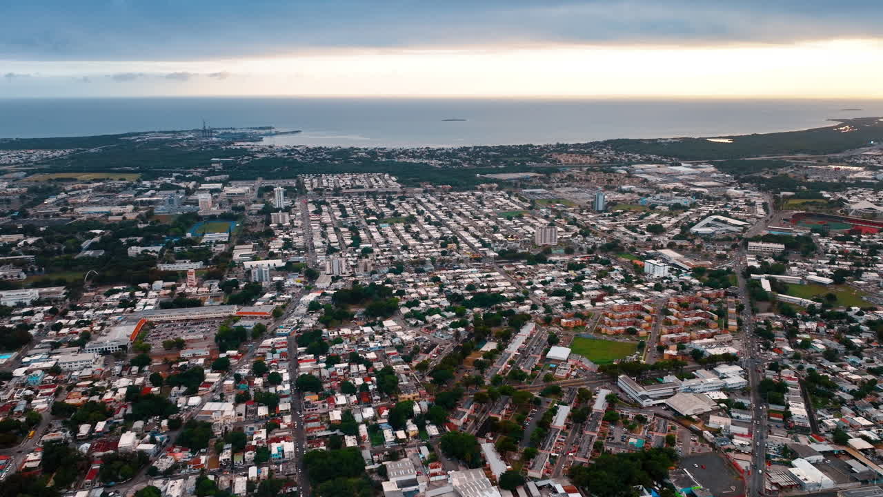 Densa paesaggio urbano di edifici bassi sulla costa oceanica. Scenario di paesaggio urbano a Porto Rico al tramonto. Vista aerea.