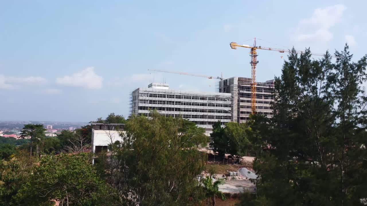 Tracking cranes above hotel construction at Mokola Hill in Ibadan, Nigeria. A rare view of reconstruction on famous Premier Hotel.