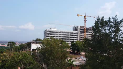 tracking cranes above hotel construction at mokola hill in ibadan, nigeria. a rare view of reconstruction on famous premier hotel.