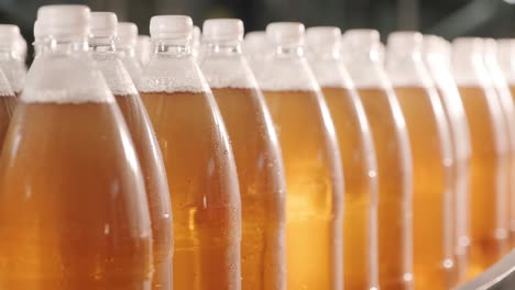 conveyor belt with bottles for juice or water at a modern beverage plant. modern production of sweet soda water