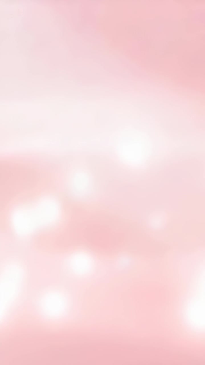 Video vertical: Degradado rosa suave animado formando orbes luminosos y difuminados en formato vertical para un brillo suave.