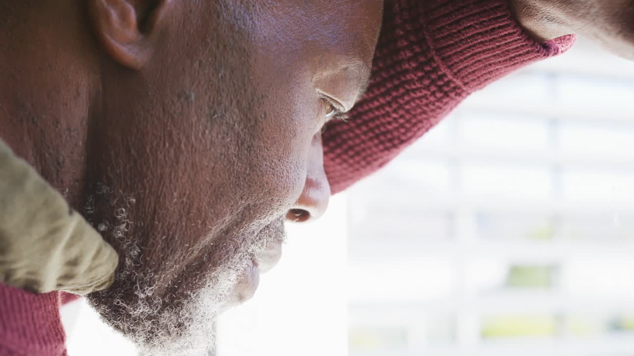 Video of thoughtful senior african american men sitting in living room alone