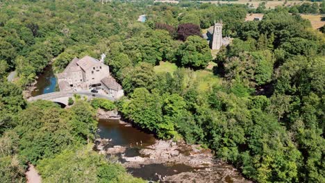 High-ariel-drone-footage-view-of-the-famous-Aysgarth-Falls-The-three-stepped-waterfalls-at-Aysgarth-have-been-a-tourist-attraction-for-over-200-years