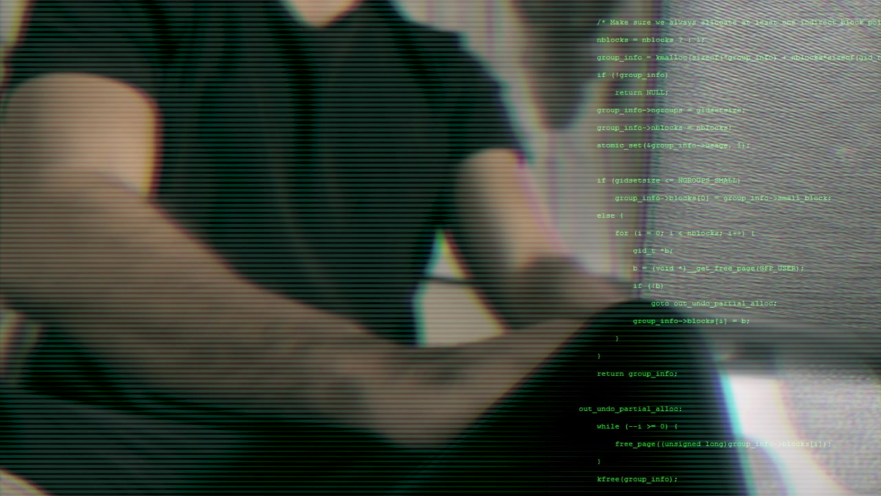 Close-up of man coding with green text overlay. Cybersecurity and data protection concept