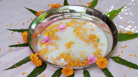 agua de leche guardada en la bañera decorada para el primer baño sagrado para el bebé indio recién nacido en casa