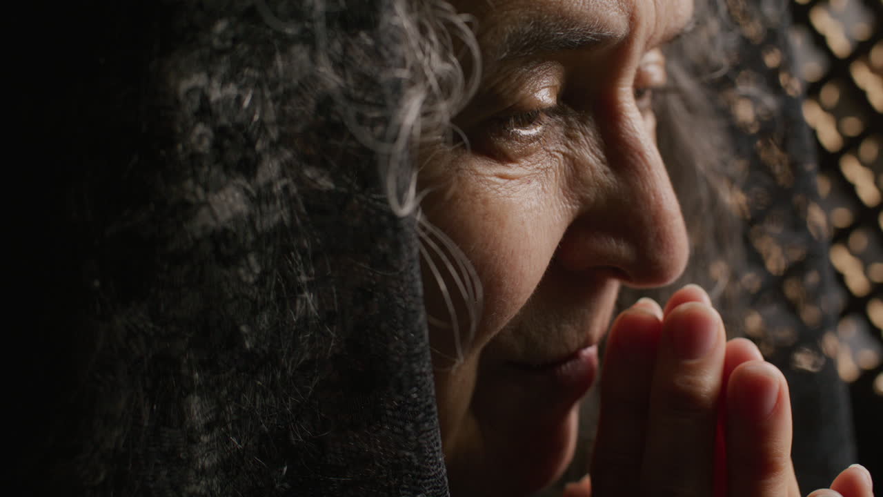 Elderly Woman in Mantilla Whispering Prayer during Confession