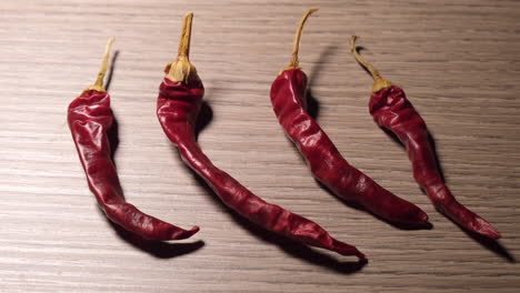 chili peppers illuminated on wooden background