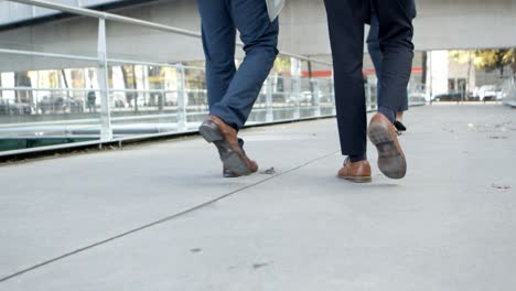 low section of business colleagues walking on street