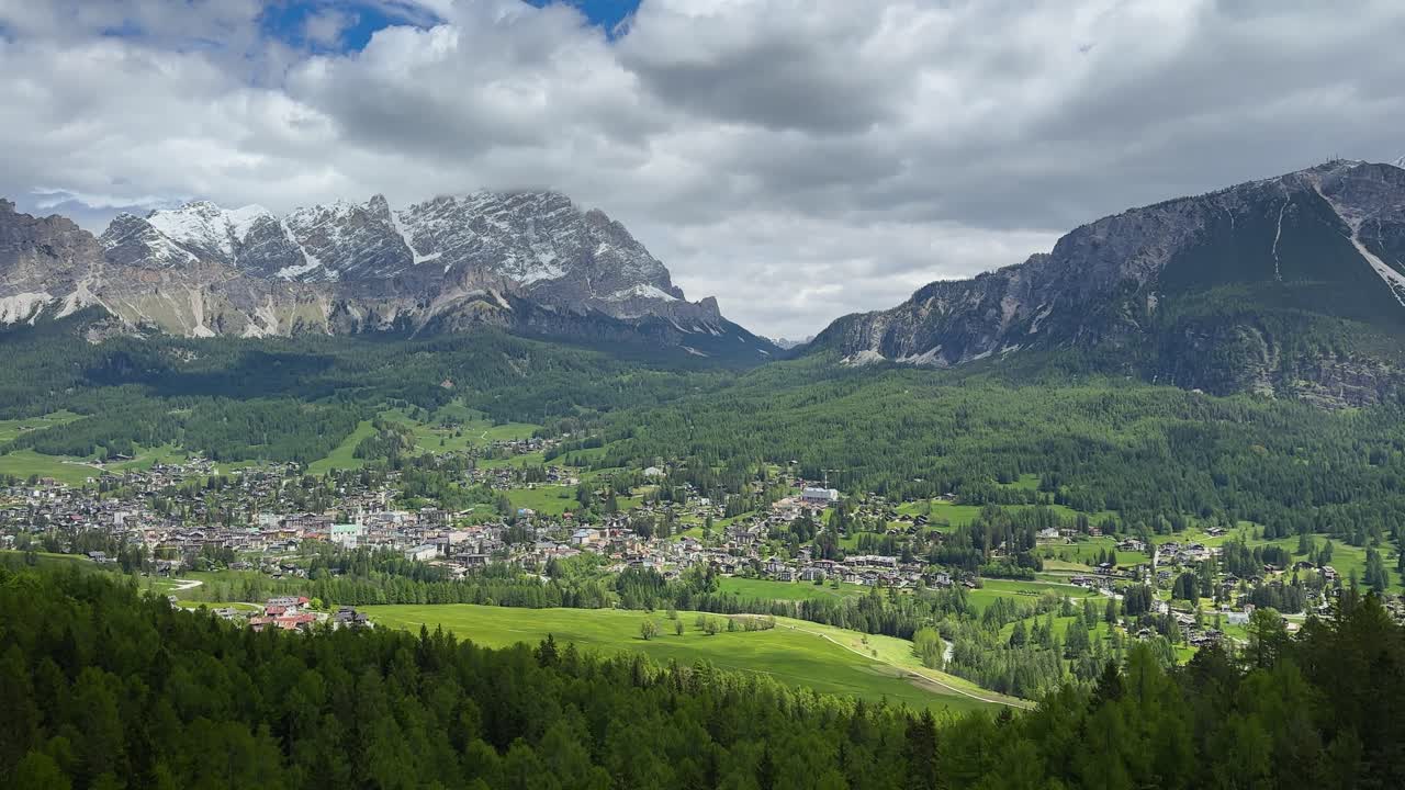 Cortina d'Ampezzo in the Dolomites, with snow-capped peaks, green valleys