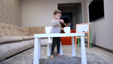 child drawing at a table in a cozy room. young child focused on drawing at a small table in a comfortable living room with soft lighting