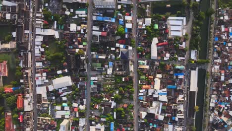 aerial: drone flies forward high above residential blocks separated by streets in densely populated nakhon ratchasima town in korat province, thailand