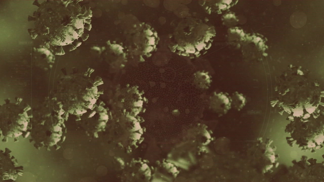 Animation of virus cells over light spots on green background