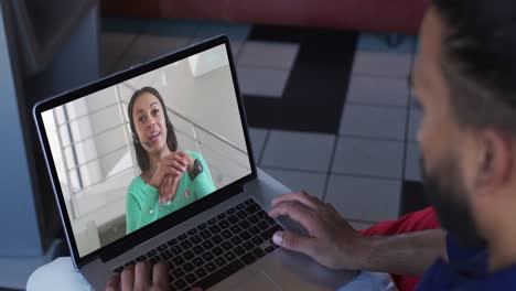 African-american-businessman-using-laptop-having-video-call-with-female-colleague