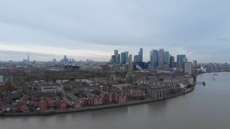 slider drone shot of canary wharf london over thames river