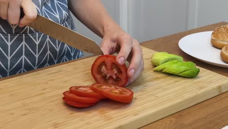 woman preparing ingredients for a burger