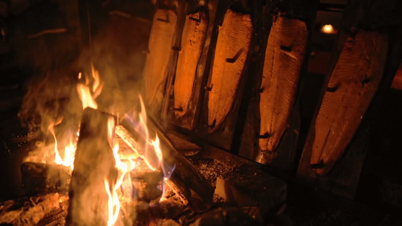 Traditional method of cooking salmon over open fire, Lapland, Finland