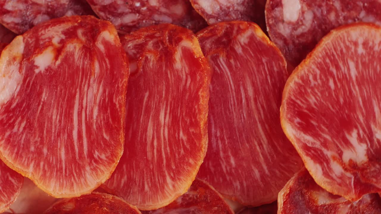 Mix of spanish pork sausages, Cutting board of appetizing catalonian snack - fuet, jamon, chorizo, olives, supermarket tapas food in spain, traditional cuisine.