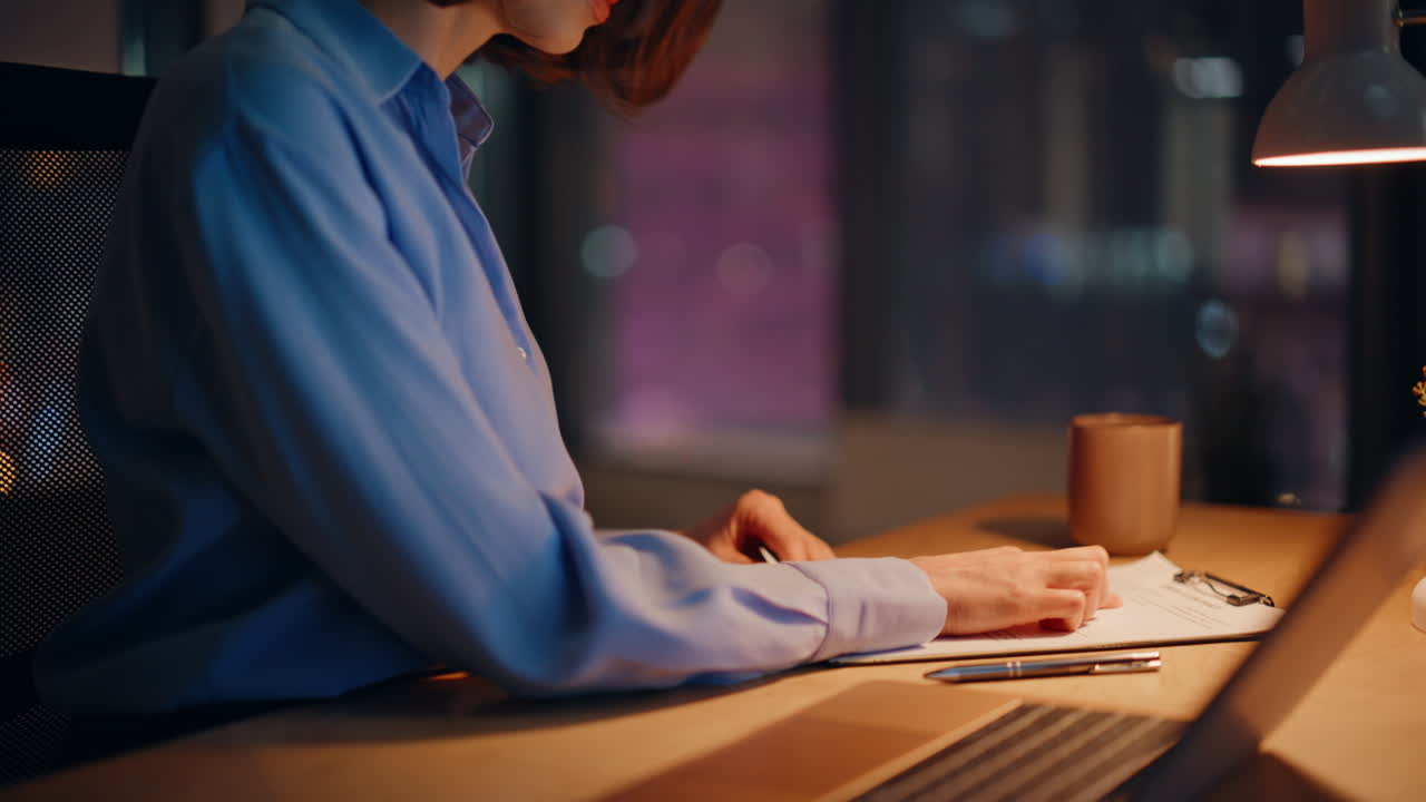 Woman financier working late checking business documents at night office closeup