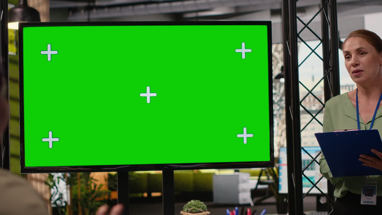 Female coworkers team use isolated TV monitor to support the business briefing