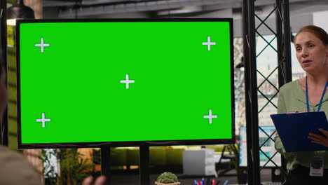 female coworkers team use isolated tv monitor to support the business briefing