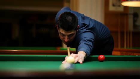 man playing billiards on a green table
