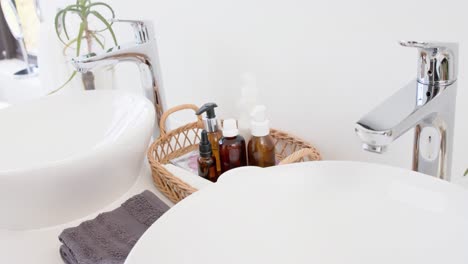 close up of washbasin and accesories in bathroom, slow motion