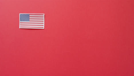 national flag of usa lying on red background with copy space