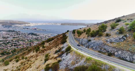 Vista-Aérea-Footage-Soaring-Over-Montaña-Range-And-Descending-To-Coastal-Village-2