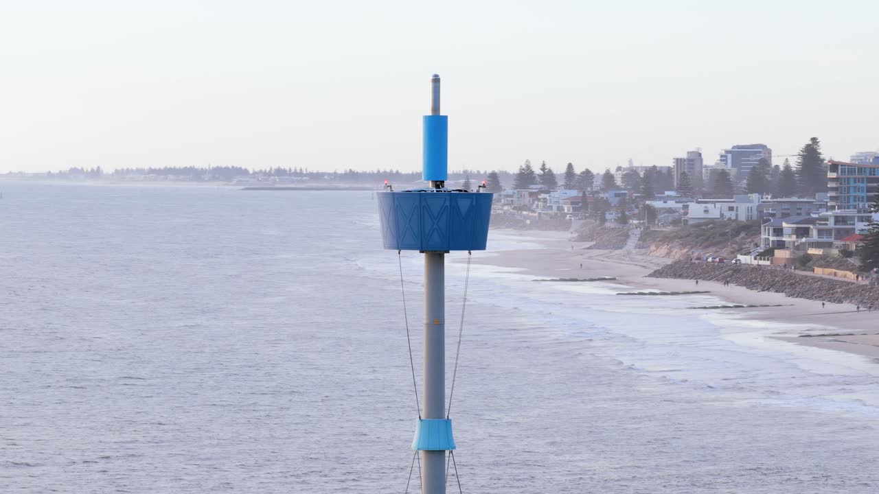 Cinematic drone close-up of iconic Brighton Beach tower and jetty and suburbs, Adelaide, South Australia