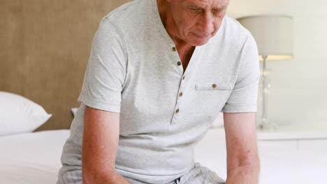 Worried-senior-man-on-bed