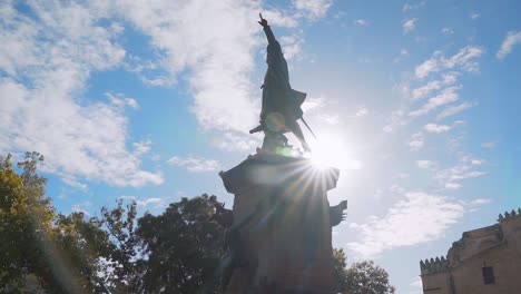 Christopher Columbus statue in the colonial zone of Santo Domingo, flying pigeons, penetrating sunbeam, portrait shot