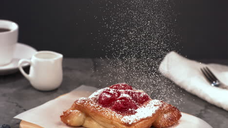 super slow motion tilt down shot of powdered sugar being sprinkled on a pastry cake. shot with high speed camera at 420 fps