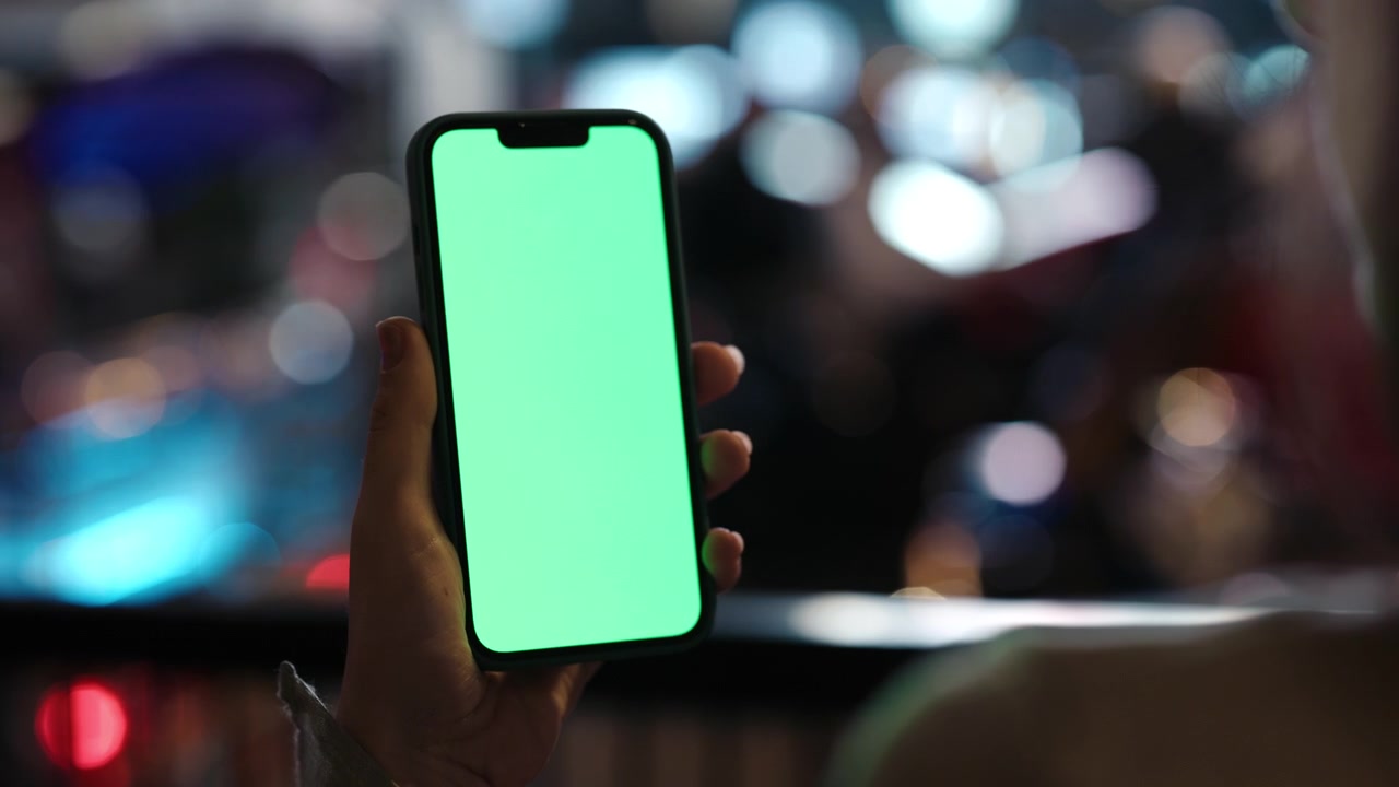 Hand Holding Vertical Smartphone with Green Screen Display