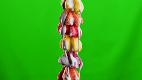 colorful stacked meringues with dripping frosting