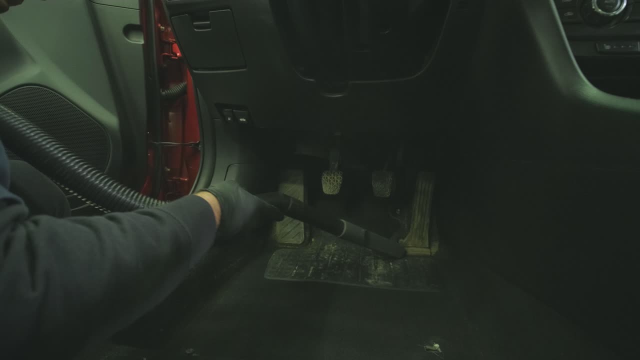 Professional car cleaning. Сar wash. Interior detailing. Dry clean and detail a car interior. Deep seats cleaning. Wiping foam in car wash. Cleaning the car panel from dust. A vacuum cleaner