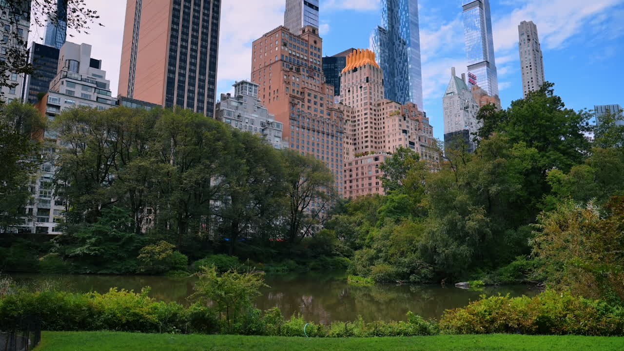 New York, USA, 28 July 2025: Discovering Central Park's beauty. Visitors enjoy the serene landscape of Central Park, surrounded by Manhattan's towering buildings and lush greenery