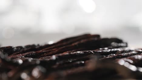 Close-up-of-Vanilla-beans-on-wooden-board,-Tracking-in-Shot---Selective-focus