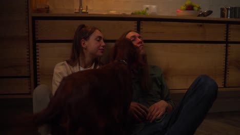 couple spending time with their dog in kitchen