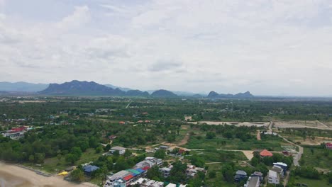 aerial view of coastal village with mountains in the background