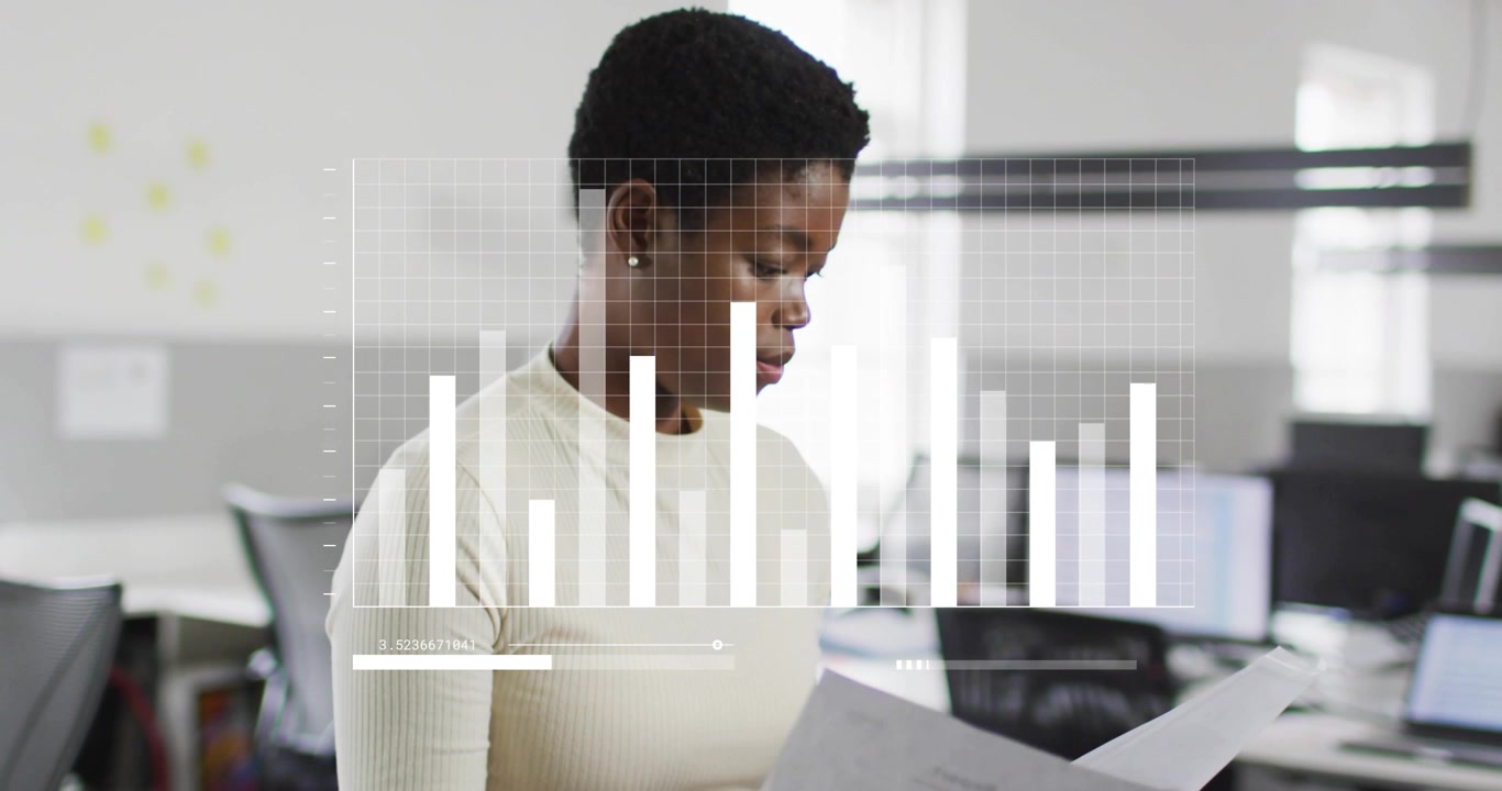 Woman standing in office reviewing business pages, shifting them and revealing clear data overlay