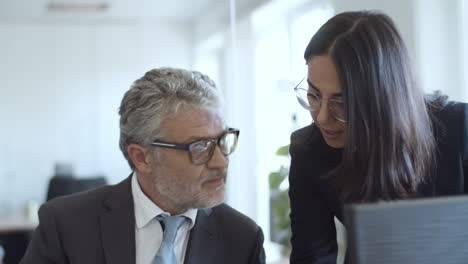 focused positive female assistant explaining document details