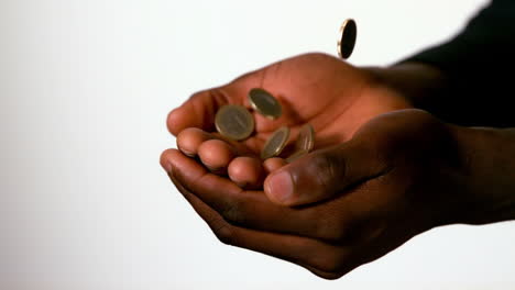 Businessman-catching-falling-coins-in-hands