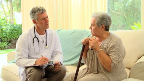 doctor writing a prescription for his patient