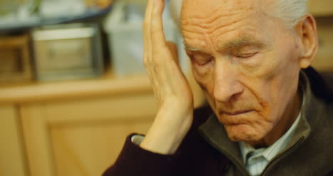 old man having headache pain