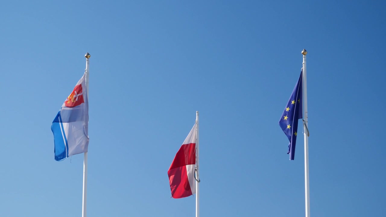 Waving flags of the city of Gdynia, Poland and European Union in slow motion x0,5.